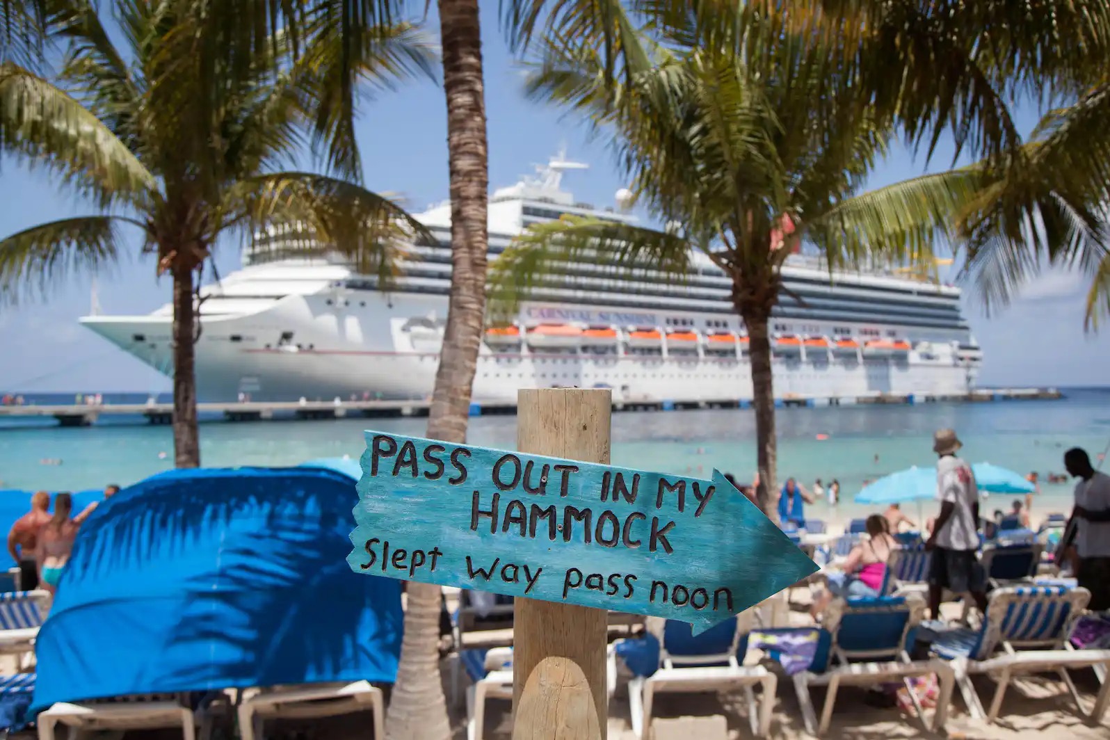 Cruise ship docked in Caribbean. beach and beach chairs